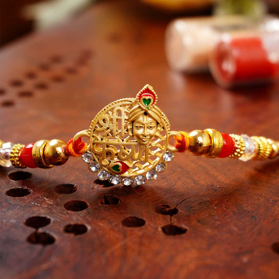 Urmika Shri Krishna Golden Color Rakhi with Roli Chawal