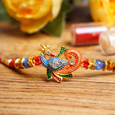 Urmika Peacock Rakhi with Red Thread with Roli Chawal