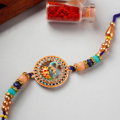 Urmika Peacock Rakhi with Blue Thread with Roli Chawal